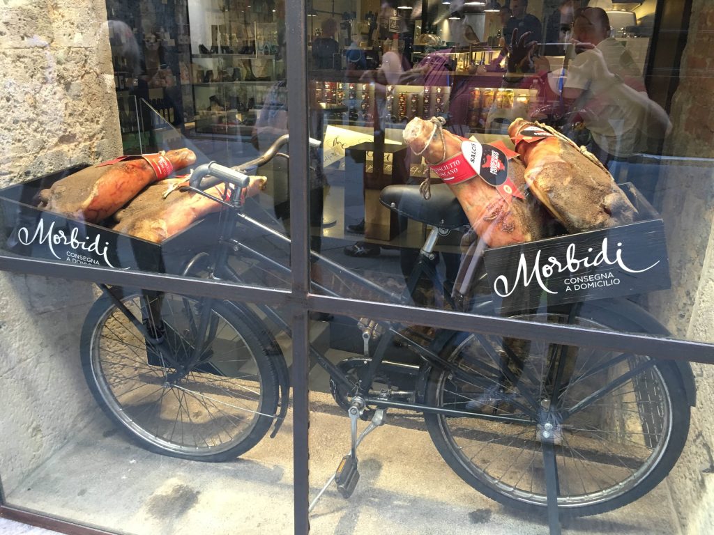 A tour explores the local food shop in Siena